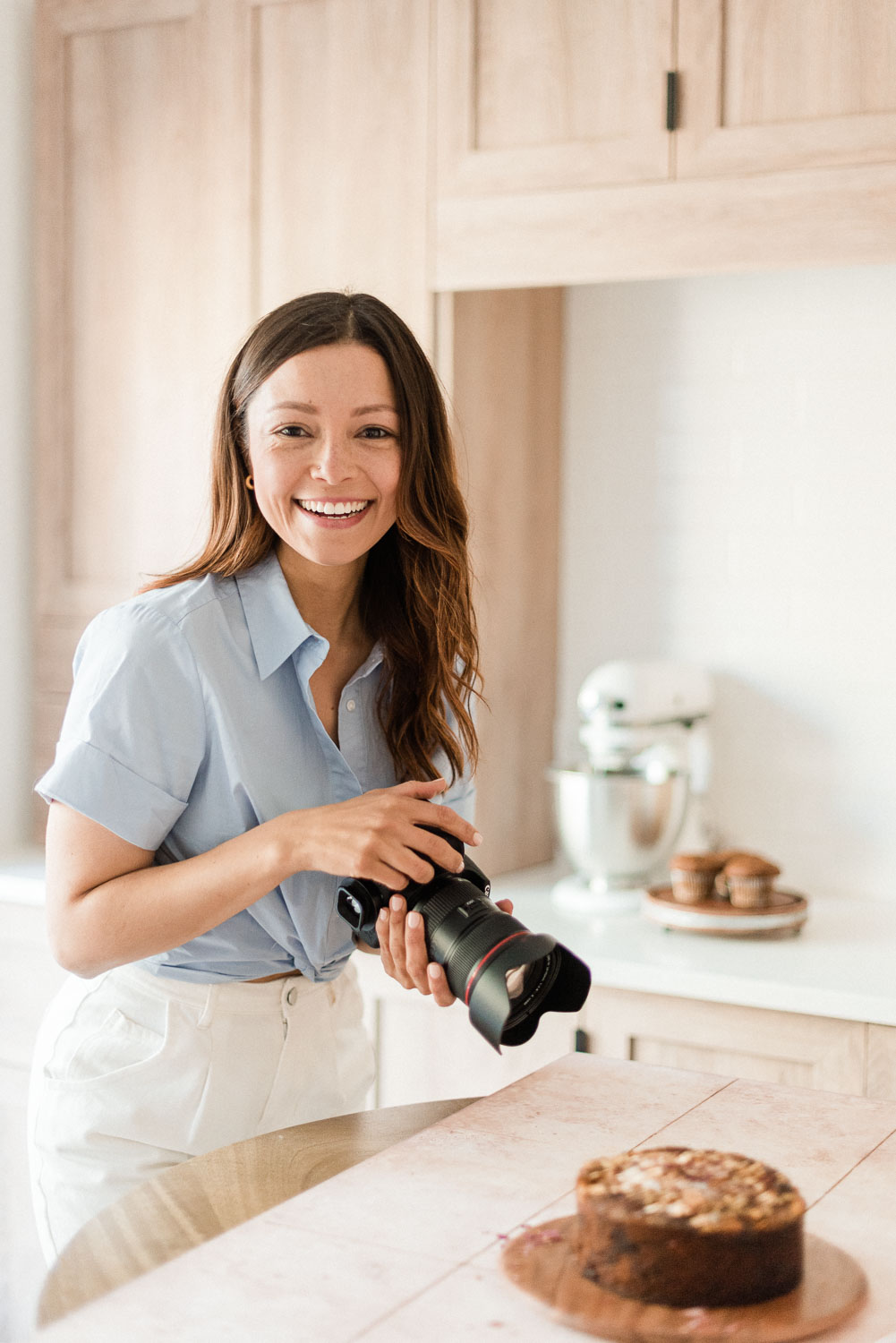 Caroline of 'Keep it Caro' holding a camera which photographing a recipe creation